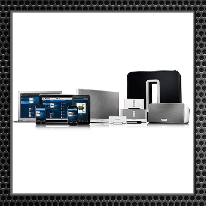 A display of various smart home devices including tablets, smartphones, speakers, and docking stations.